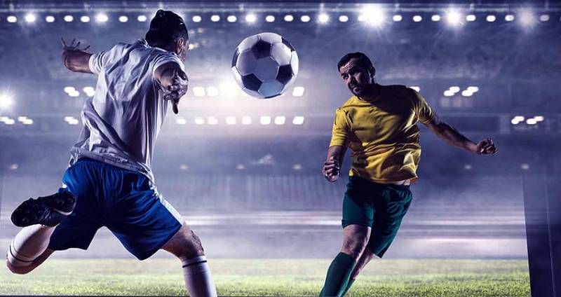 2 football players chasing a ball in the stadium