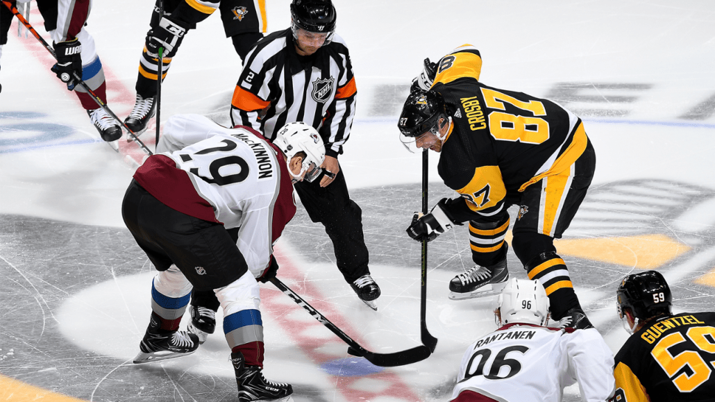 ice hockey players fighting for puck